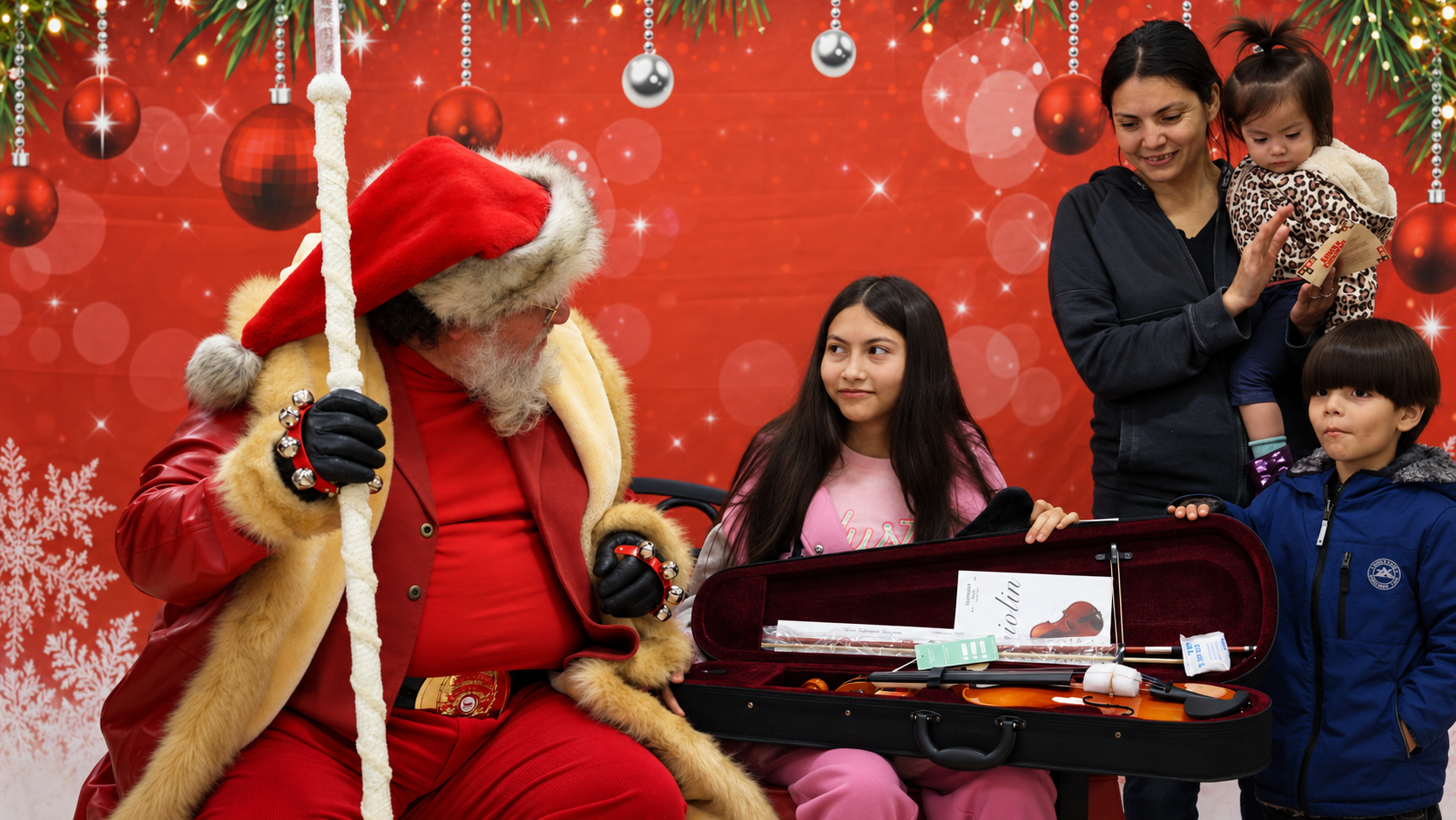 Santa interacting with a family during a Christmas outreach event